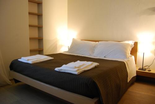 a bedroom with a bed with two towels on it at Ceccarini Suite in Riccione