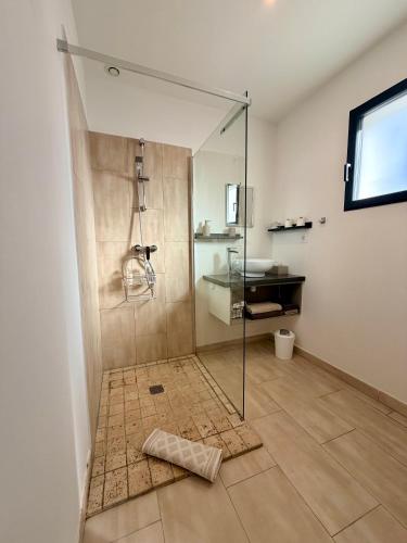 a bathroom with a shower with a glass door at CARPE DIEM Résidence Hôtelière in Lorgues