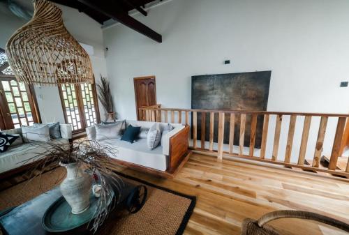 a living room with a couch and a table at Tara Luxury House in Habaraduwa Central