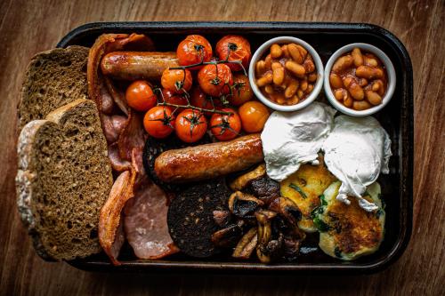 a tray of food with sausage beans beans and bread at The Smugglers Rest in Woolacombe