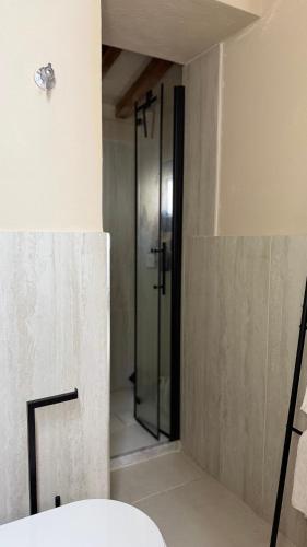 a bathroom with a shower with a glass door at Porto 24 in Portoferraio