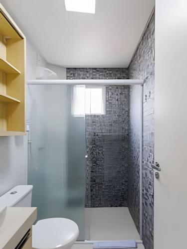a bathroom with a shower and a toilet at Curta Praia do Quilombo - Palladium in Penha