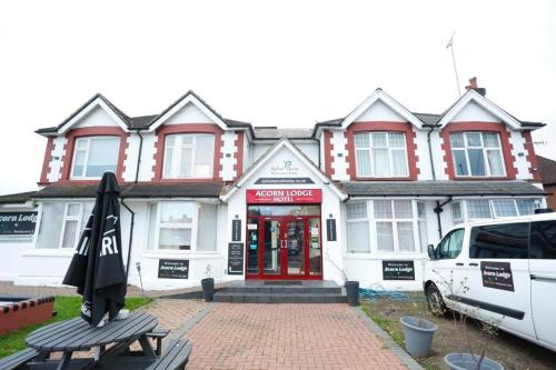 a white van parked in front of a building at Acorn Lodge Hotel Gatwick & Parking in Horley