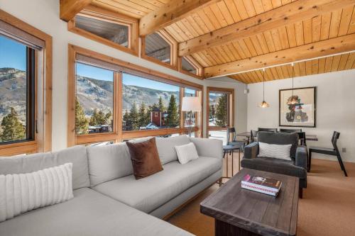 a living room with a couch and a table at Shadow Mountain 10 in Aspen