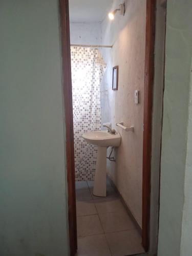 a bathroom with a sink and a mirror at Los Cali 27 planta alta 1 in Balneario Buenos Aires