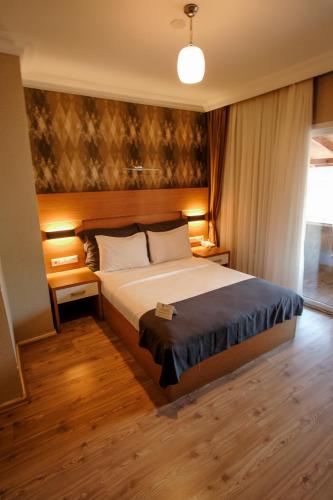 a bedroom with a large bed in a room at Rhisos Otel in Rize