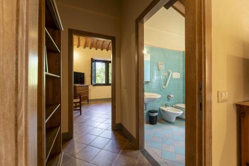 a bathroom with a tub and a toilet and a sink at Villa Montarioso in Siena