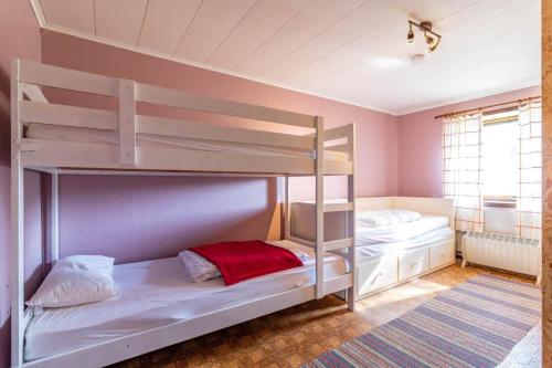 a bedroom with two bunk beds and a window at KRO906-Lidhult-Torseryd-4 in Lidhult