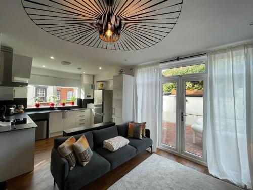 a living room with a couch and a kitchen at Cozy Organic Tea House in Central Ipswich near Waterfront, University and Hospital in Ipswich