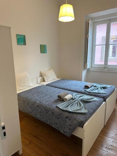 a bedroom with two beds with towels on it at Sintra Flower Camelia Apartment in Sintra