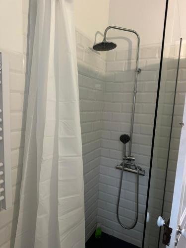 a shower with a shower curtain in a bathroom at Sintra Flower Camelia Apartment in Sintra