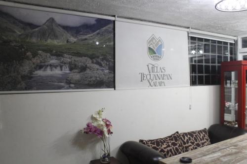 a wall with a sign on it with a couch at Villas Tecuanapan in Xalapa