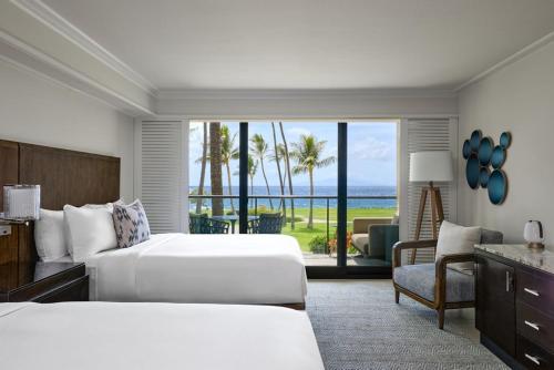 a hotel room with two beds and a view of the ocean at Wailea Beach Resort - Marriott, Maui in Wailea