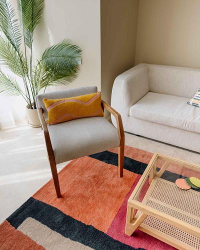 a living room with a chair and a couch at Villette Serviced Apartments in Sodic New Cairo in New cairo