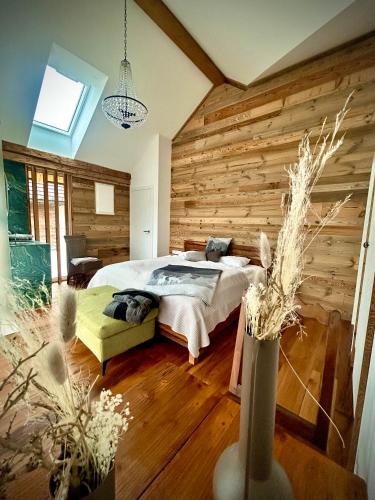 a bedroom with a bed in a wooden wall at SeeChalet Hallstatt in Bad Goisern