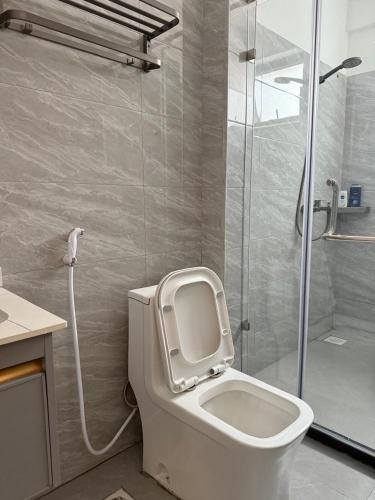 a bathroom with a toilet and a shower at The Nirvana Place in Nairobi