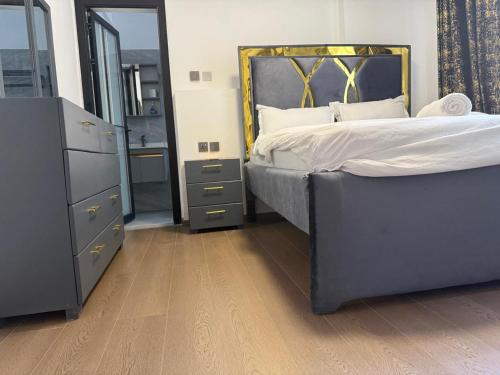 a bedroom with a bed and a dresser and a mirror at The Nirvana Place in Nairobi