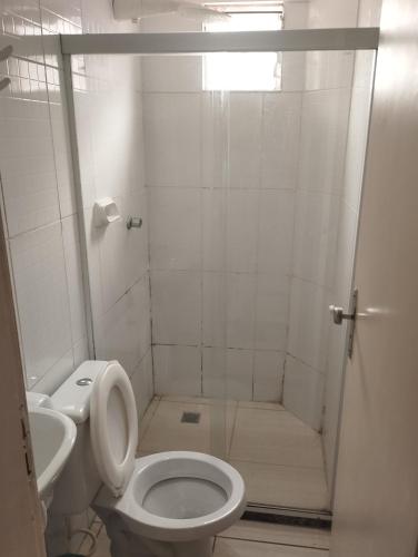 a bathroom with a shower with a toilet and a sink at Motel pousada Zafira in Salvador