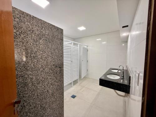 a bathroom with a sink and a toilet in it at Hotel Nova Sorocabana in Brodósqui