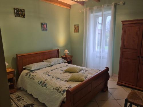 a bedroom with a bed with two pillows on it at Le gite du gueurlet in Boresse-et-Martron