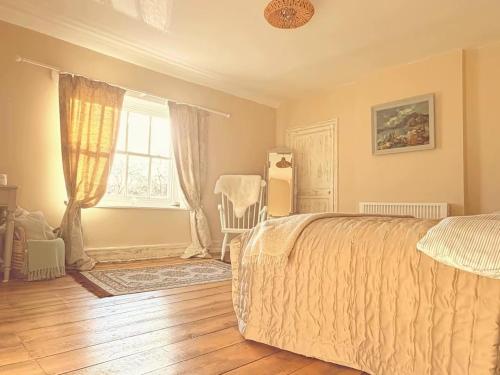 a bedroom with a bed and a window at Beehive Cottage in Beccles