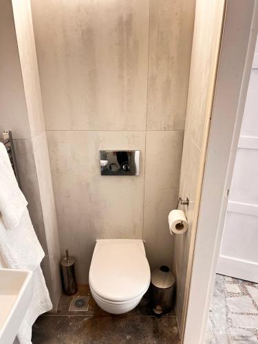 a small bathroom with a toilet and a sink at Old Town Retreat in Rhodes Town