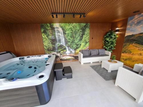a jacuzzi tub in a room with a waterfall at Agroturystyka Gazdówka in Zakliczyn