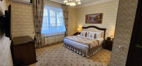 a hotel room with a bed and a window at Hotel Asia Khiva in Khiva