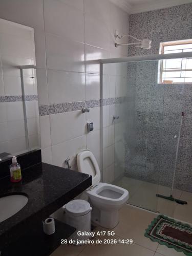 a bathroom with a shower and a toilet and a sink at Vanildo Oliveira in Uberlândia