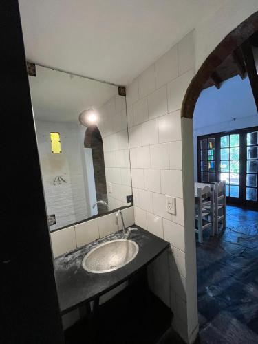 a bathroom with a sink and a mirror at La Huella in Chascomús