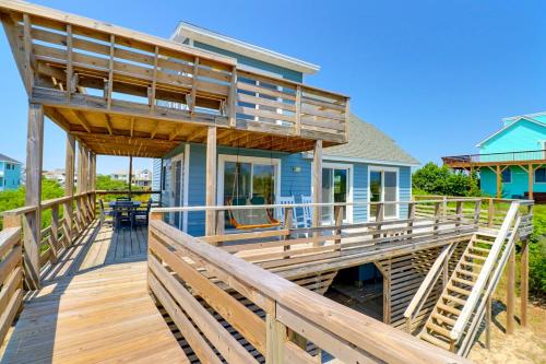a home with a wooden deck and a house at 1245 - Castle Sween in Corolla