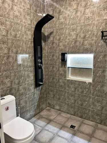 a bathroom with a shower with a phone on the wall at IN 2 Chalet in Jeddah