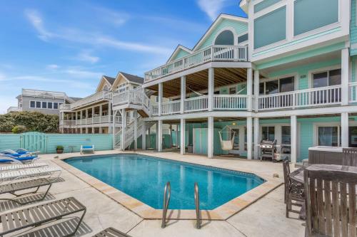 an exterior view of a house with a swimming pool at 1398 - Alotta Coladas in Corolla