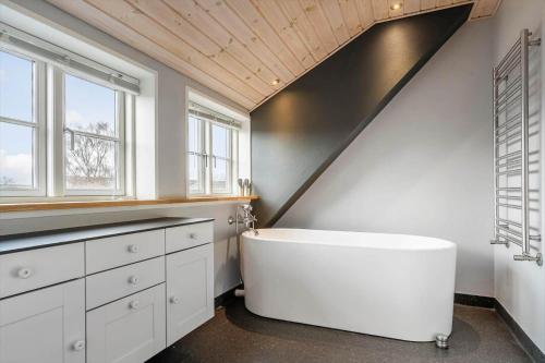a bathroom with a large white tub in a room at 20426-Samso-Nylandsvej-21 in Ballen