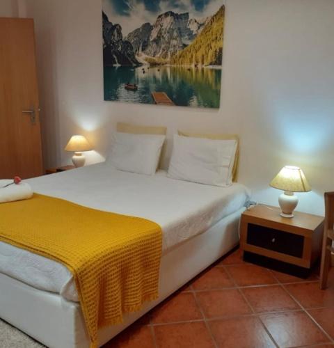 a bedroom with a bed and a painting on the wall at Casa Afonso in Ventosa