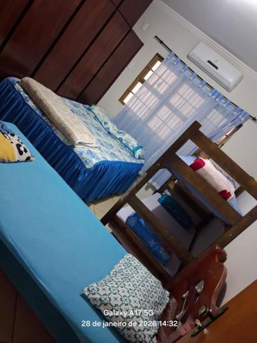 a room with two beds and a sewing machine at Vanildo Oliveira in Uberlândia
