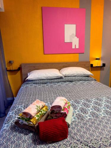 a bedroom with a bed with two towels on it at Riviera Begonia Appartement - Parking Privé in Roquebrune-Cap-Martin