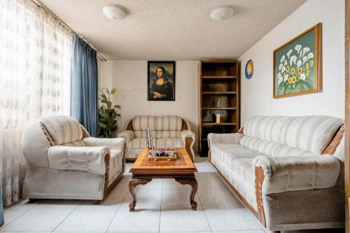 a living room with two couches and a coffee table at Near Everything and Some Art in Mexico City