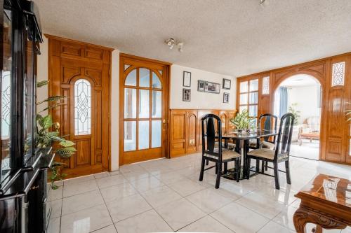 a dining room with a table and chairs at Near Everything and Some Art in Mexico City