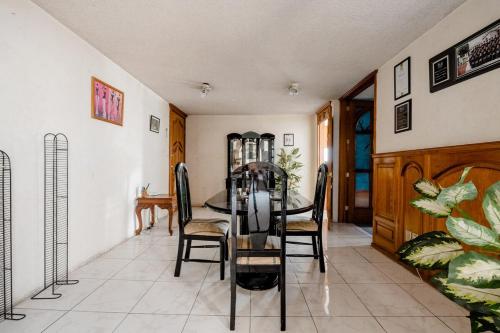 a dining room with a table and chairs at Near Everything and Some Art in Mexico City