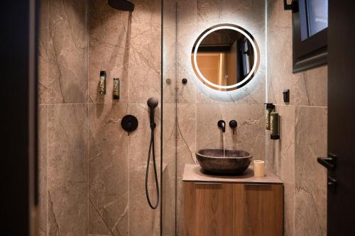 a bathroom with a sink and a shower at Alkioni Boutique Hotel in Pýli