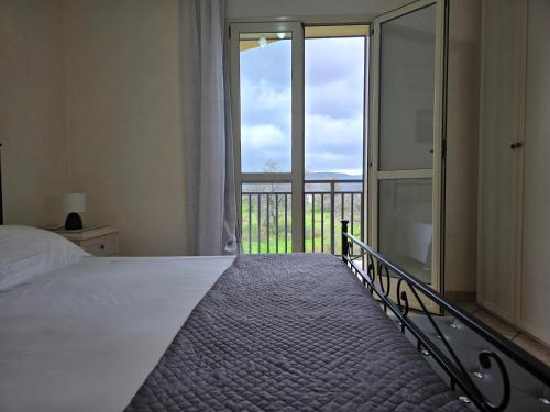 a bedroom with a bed and a large window at Villa Sara in Floridia