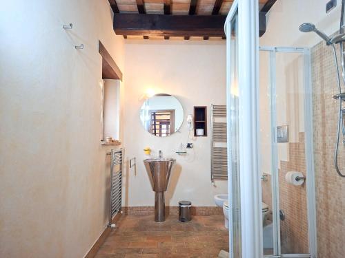 a bathroom with a shower and a sink and a mirror at Villa Santa Maria in Montegiorgio