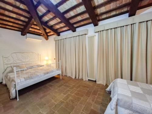 a bedroom with two beds and a wooden ceiling at Villa Santa Maria in Montegiorgio