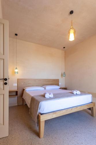a bedroom with a large bed with towels on it at Suite & Spa Carignano Grande in Nardò