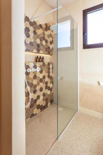 a shower with a glass door in a bathroom at Suite & Spa Carignano Grande in Nardò