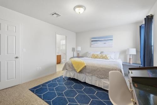 a bedroom with a bed and a blue rug at The Alturas in Alamogordo