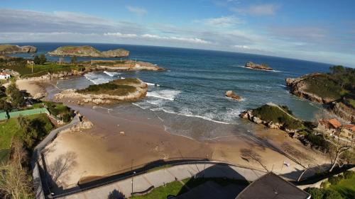 an aerial view of a beach with rocks in the water at Cala Tatina in Celorio