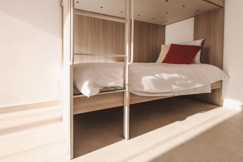 a bedroom with a bunk bed with a mirror at Seaside Luxury Home with Rooftop Pool in Birżebbuġa