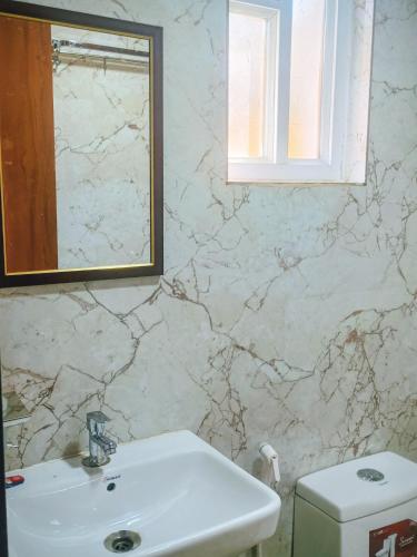 a bathroom with a sink and a mirror at Hotel Venus in Jabalpur